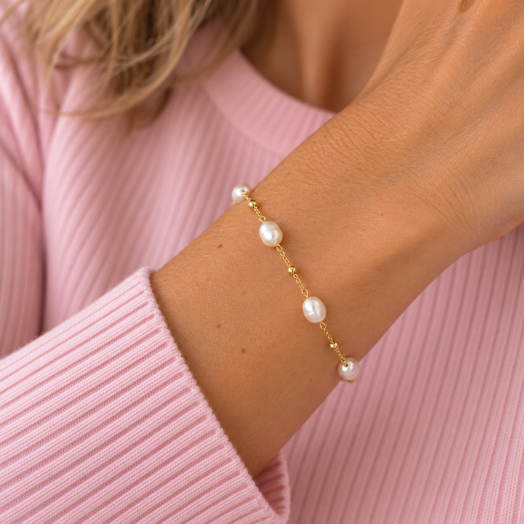 Bardot gold plated sterling silver freshwater pearl bracelet worn with pale pink ribbed top