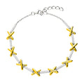 Taylor bracelet in 18 carat gold vermeil and sterling silver featuring polished gold kiss motifs with sprakling cubic zirconia links. 